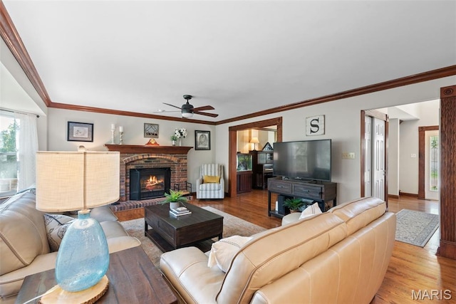 2854 Championship Blvd, Saint Louis, MO 63129 - living area with ceiling fan, wood finished floors, a fireplace, crown molding, and baseboards