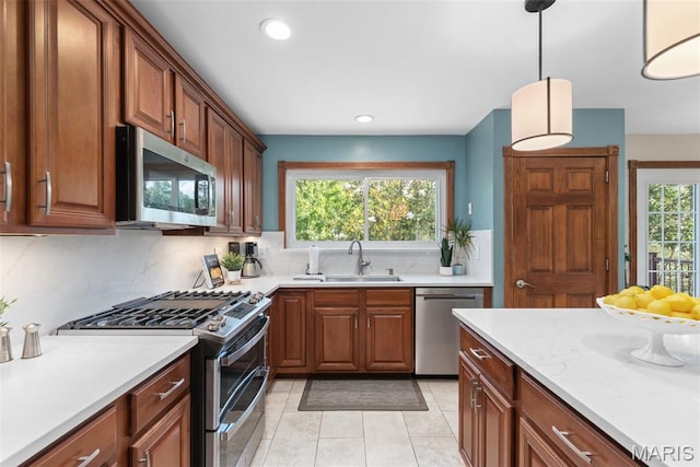 2854 Championship Blvd, Saint Louis, MO 63129 - kitchen with stainless steel appliances, a sink, decorative backsplash, light tile patterned floors, and recessed lighting