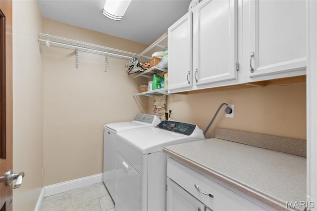 2854 Championship Blvd, Saint Louis, MO 63129 - washroom with cabinet space, washer and dryer, baseboards, and light tile patterned floors