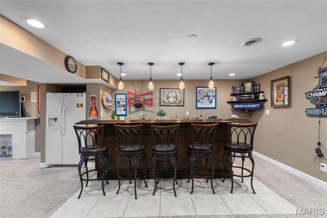 2854 Championship Blvd, Saint Louis, MO 63129 - indoor wet bar featuring white refrigerator with ice dispenser, baseboards, light carpet, recessed lighting, and decorative light fixtures
