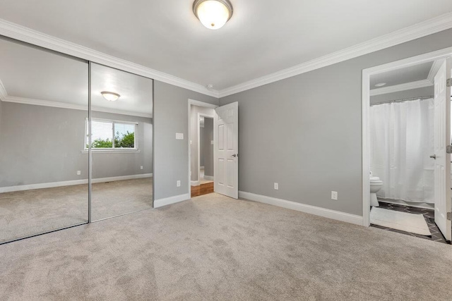 1354 Nutmeg Dr, Saint Charles, MO 63303 - unfurnished bedroom with a closet, carpet, crown molding, baseboards, and connected bathroom