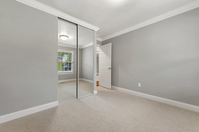1354 Nutmeg Dr, Saint Charles, MO 63303 - unfurnished bedroom featuring carpet flooring, a closet, ornamental molding, and baseboards