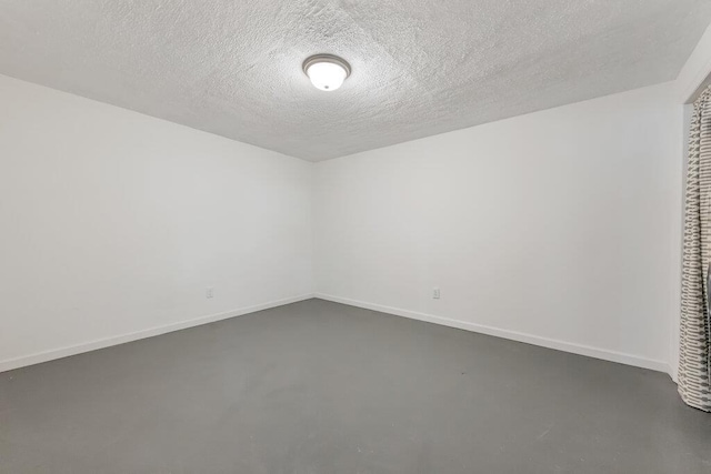 1354 Nutmeg Dr, Saint Charles, MO 63303 - unfurnished room with concrete flooring, baseboards, and a textured ceiling