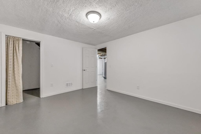 1354 Nutmeg Dr, Saint Charles, MO 63303 - unfurnished bedroom with baseboards, a textured ceiling, and concrete flooring