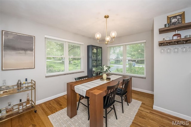 7 Frederick Ln, Saint Louis, MO 63122 - dining space featuring baseboards, wood finished floors, and a chandelier