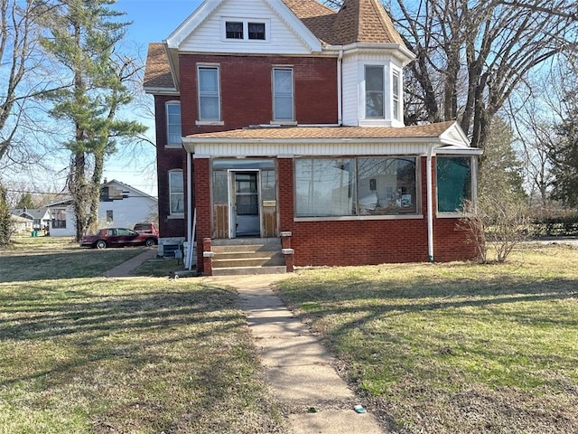 7603 State St E, St Louis, IL 62203 - view of front of house with entry steps, a front yard, and brick siding