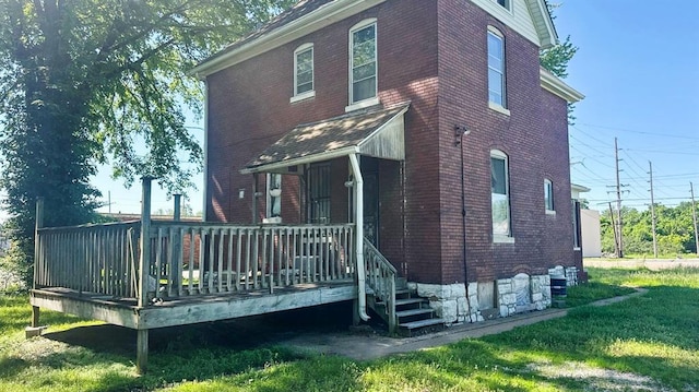7603 State St E, St Louis, IL 62203 - rear view of property featuring brick siding and a yard