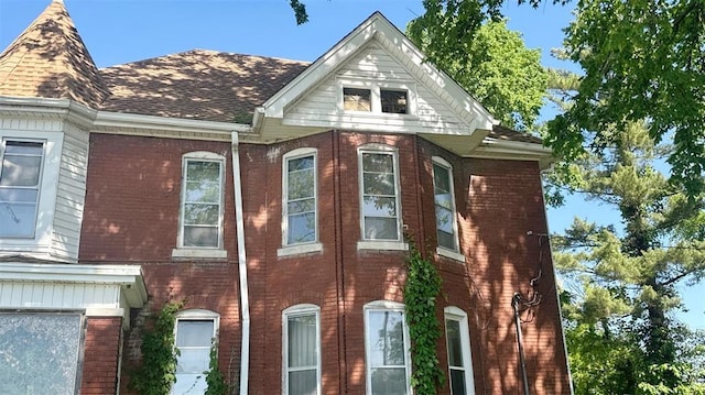7603 State St E, St Louis, IL 62203 - view of home's exterior featuring brick siding and a shingled roof