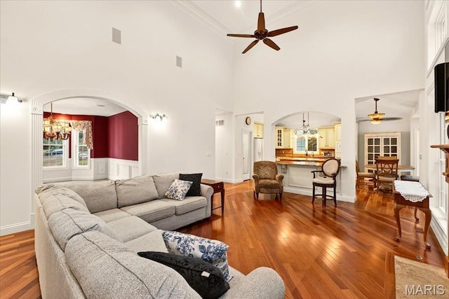 125 Park Lawn Est, Fenton, MO 63026 - living area with a ceiling fan, arched walkways, a chandelier, hardwood / wood-style flooring, and ornamental molding