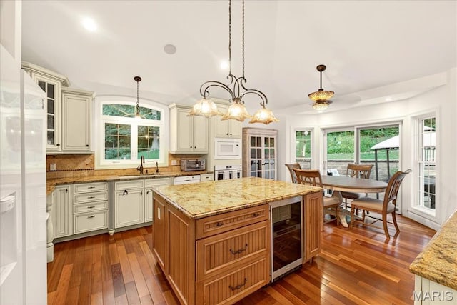 125 Park Lawn Est, Fenton, MO 63026 - kitchen featuring beverage cooler, white microwave, dark wood finished floors, oven, and vaulted ceiling