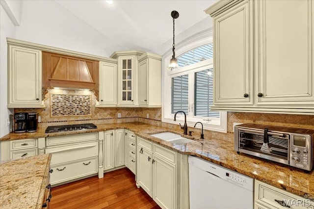 125 Park Lawn Est, Fenton, MO 63026 - kitchen featuring dishwasher, cream cabinets, stainless steel gas stovetop, vaulted ceiling, and decorative light fixtures