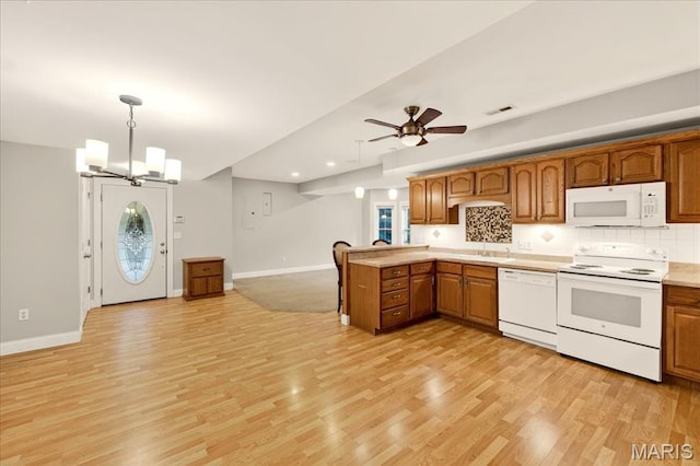125 Park Lawn Est, Fenton, MO 63026 - kitchen with white appliances, a peninsula, light wood-style flooring, pendant lighting, and recessed lighting