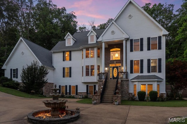 125 Park Lawn Est, Fenton, MO 63026 - greek revival inspired property with curved driveway, stairs, a shingled roof, and stone siding