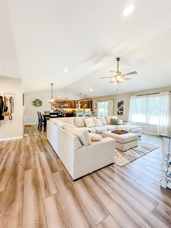 20083 Southview Dr, Carlyle, IL 62231 - living area featuring vaulted ceiling, light wood-style floors, a ceiling fan, baseboards, and recessed lighting