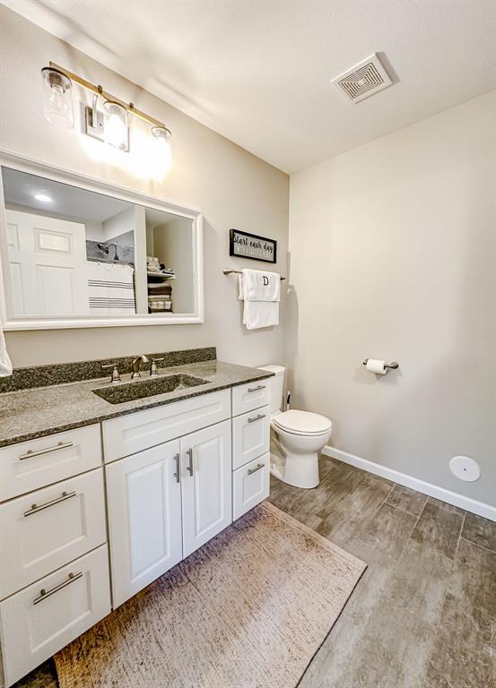 20083 Southview Dr, Carlyle, IL 62231 - full bath featuring vanity, wood finished floors, toilet, and baseboards