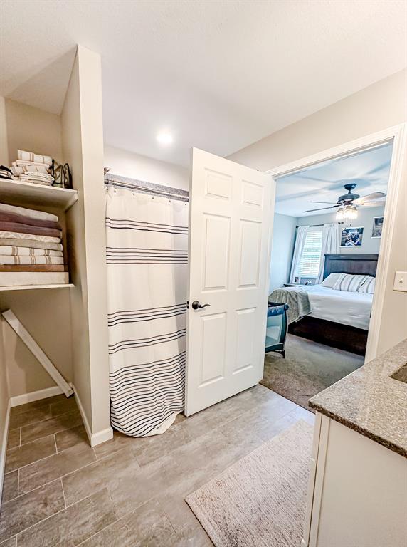 20083 Southview Dr, Carlyle, IL 62231 - ensuite bathroom featuring vanity, baseboards, and ceiling fan