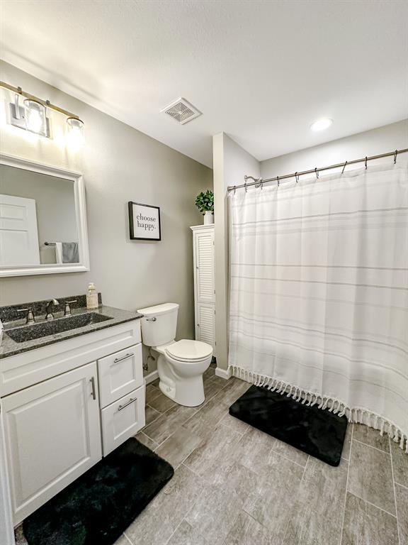 20083 Southview Dr, Carlyle, IL 62231 - full bathroom with toilet, vanity, baseboards, and a shower with shower curtain
