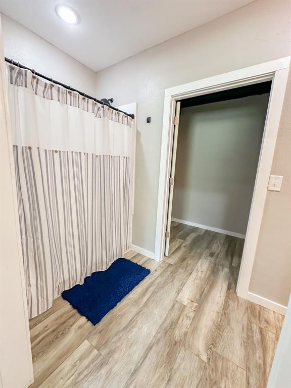 20083 Southview Dr, Carlyle, IL 62231 - bathroom featuring wood finished floors, baseboards, and a shower with curtain
