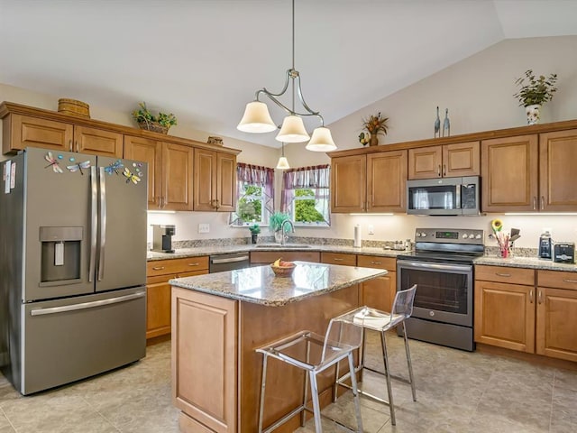 1051 Creekside Dr, Waterloo, IL 62298 - kitchen featuring appliances with stainless steel finishes, a sink, a kitchen island, brown cabinets, and high vaulted ceiling