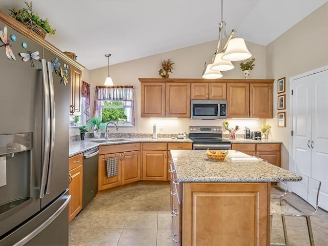 1051 Creekside Dr, Waterloo, IL 62298 - kitchen with stainless steel appliances, a sink, light stone counters, pendant lighting, and a center island