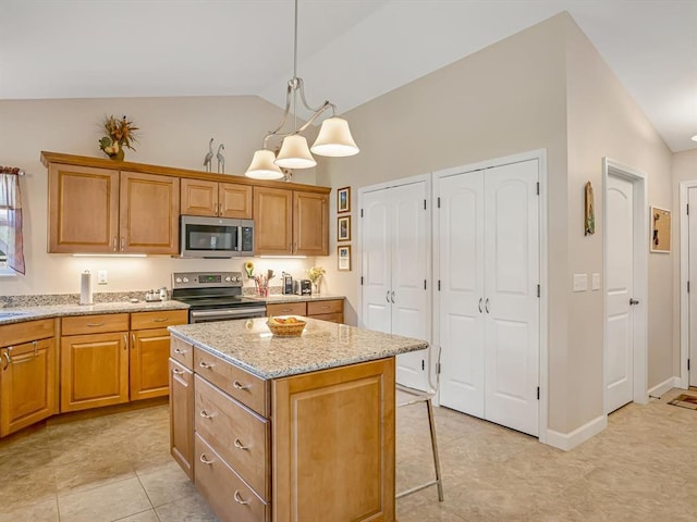 1051 Creekside Dr, Waterloo, IL 62298 - kitchen featuring stainless steel appliances, a kitchen island, light stone counters, hanging light fixtures, and a breakfast bar