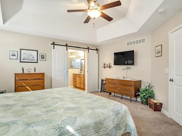 1051 Creekside Dr, Waterloo, IL 62298 - bedroom featuring a barn door, carpet flooring, a tray ceiling, ceiling fan, and baseboards