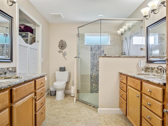 1051 Creekside Dr, Waterloo, IL 62298 - full bath featuring two vanities, a stall shower, toilet, and baseboards