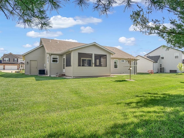 1051 Creekside Dr, Waterloo, IL 62298 - rear view of house with central air condition unit, a yard, and a sunroom