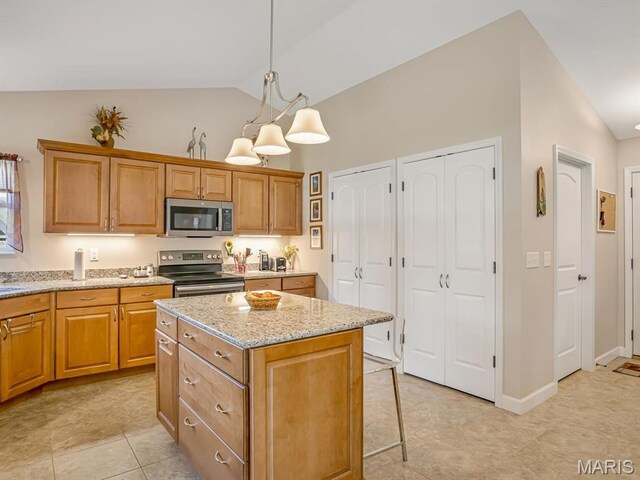 1051 Creekside Dr, Waterloo, IL 62298 - kitchen featuring appliances with stainless steel finishes, a center island, light stone countertops, hanging light fixtures, and light tile patterned floors