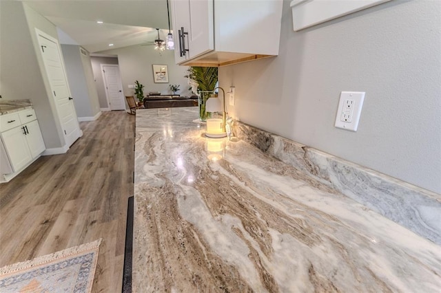 153 Mesa Dr, Waynesville, MO 65583 - kitchen featuring white cabinets, a ceiling fan, light stone countertops, and light wood finished floors