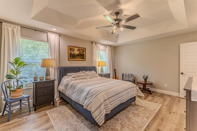153 Mesa Dr, Waynesville, MO 65583 - bedroom featuring a tray ceiling, multiple windows, light wood-style floors, baseboards, and recessed lighting