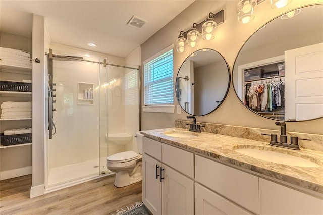 153 Mesa Dr, Waynesville, MO 65583 - bathroom with wood finished floors, a shower stall, double vanity, toilet, and recessed lighting