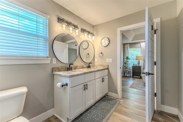 153 Mesa Dr, Waynesville, MO 65583 - bathroom featuring wood finished floors, baseboards, and double vanity