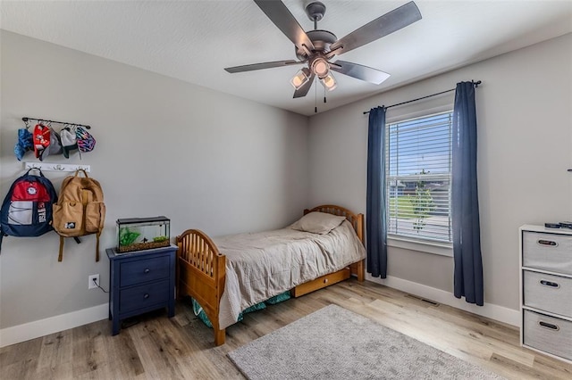 153 Mesa Dr, Waynesville, MO 65583 - bedroom with baseboards, wood finished floors, and ceiling fan