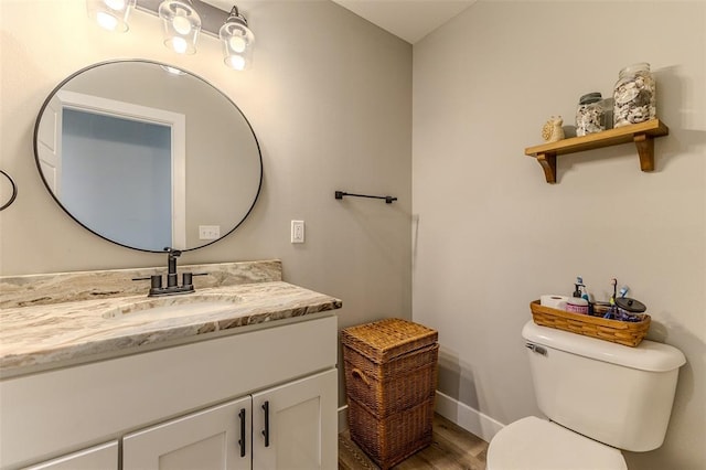 153 Mesa Dr, Waynesville, MO 65583 - half bath featuring toilet, vanity, wood finished floors, and baseboards