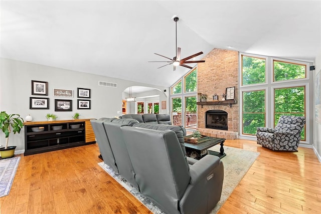 2347 Callaway Fork Rd, Defiance, MO 63341 - living area featuring arched walkways, a brick fireplace, a ceiling fan, high vaulted ceiling, and light wood-type flooring