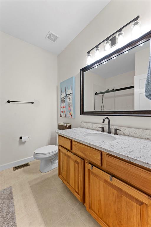 2347 Callaway Fork Rd, Defiance, MO 63341 - bathroom with vanity, toilet, a shower, and tile patterned flooring