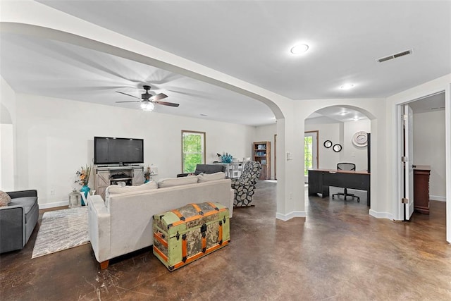2347 Callaway Fork Rd, Defiance, MO 63341 - living room with concrete flooring, baseboards, a ceiling fan, and arched walkways