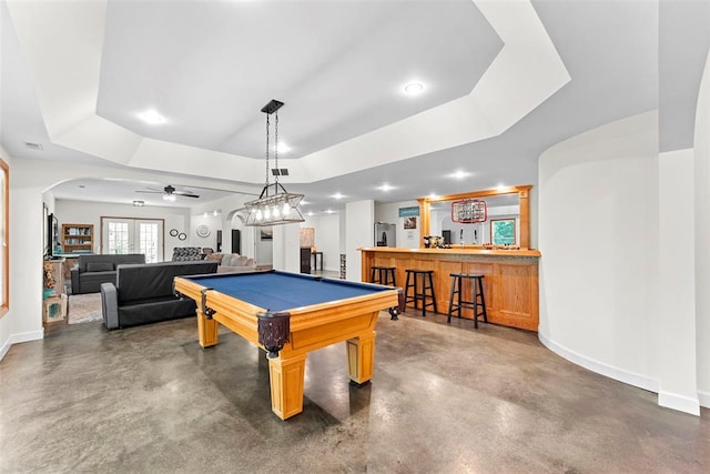 2347 Callaway Fork Rd, Defiance, MO 63341 - playroom featuring bar, concrete flooring, arched walkways, a tray ceiling, and baseboards