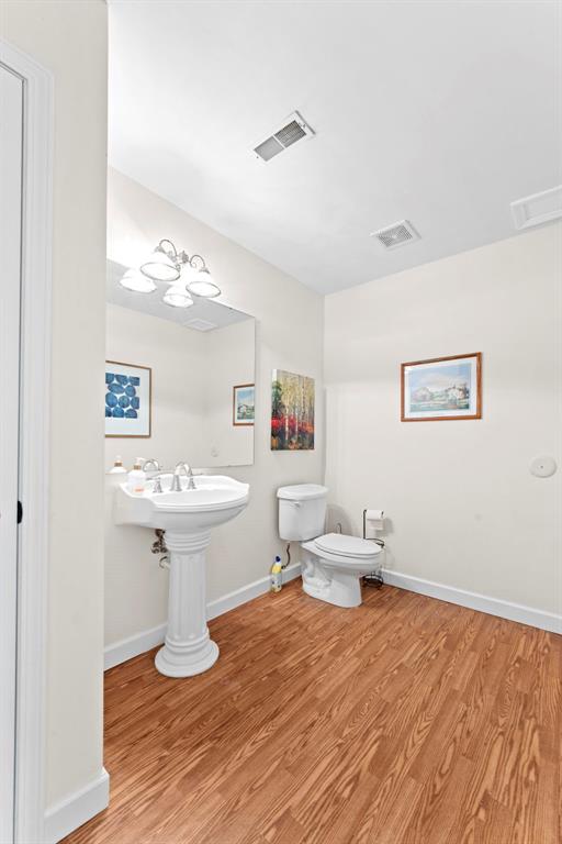 2347 Callaway Fork Rd, Defiance, MO 63341 - bathroom featuring toilet, wood finished floors, and baseboards