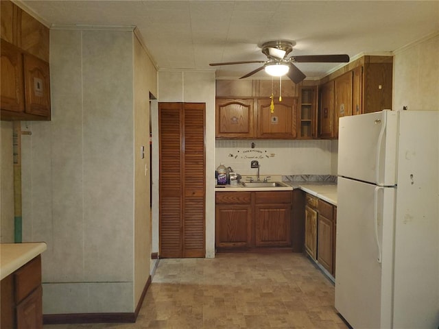 19 Agnes Dr, Cahokia, IL 62206 - kitchen featuring freestanding refrigerator, a sink, a ceiling fan, brown cabinetry, and light countertops