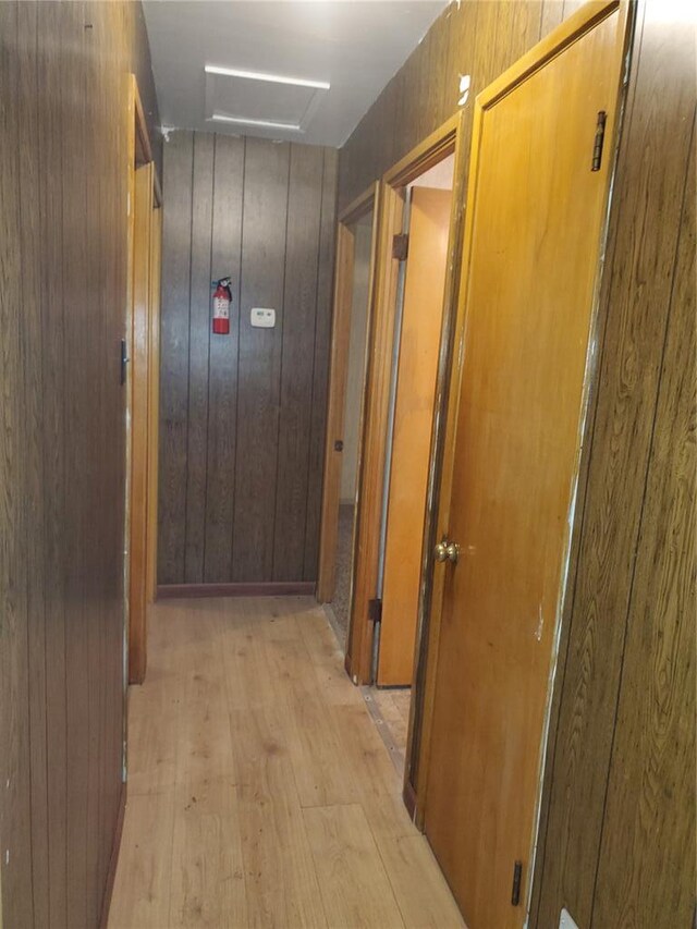 19 Agnes Dr, Cahokia, IL 62206 - hallway featuring light wood-type flooring, attic access, and wood walls