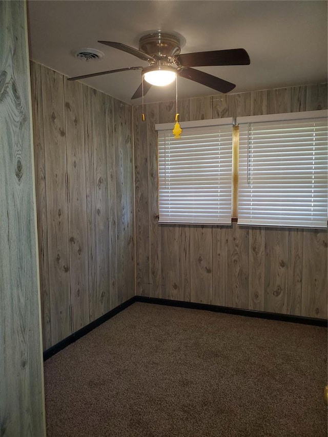 19 Agnes Dr, Cahokia, IL 62206 - carpeted empty room featuring a ceiling fan, wood walls, and baseboards