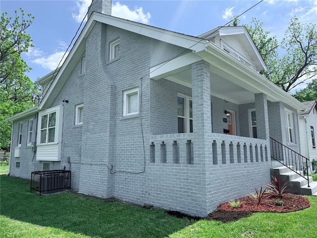 1204 Griefield Pl, Pagedale, MO 63133 - view of property exterior featuring brick siding, a chimney, and a lawn