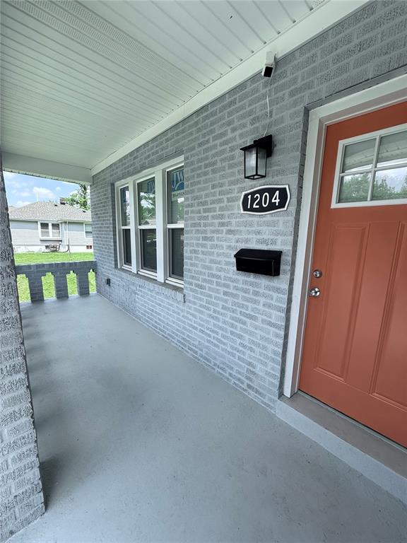 1204 Griefield Pl, Pagedale, MO 63133 - property entrance featuring a porch and brick siding