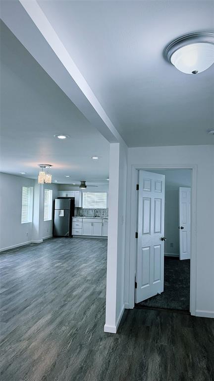 1204 Griefield Pl, Pagedale, MO 63133 - unfurnished living room with baseboards, dark wood-style flooring, a chandelier, and recessed lighting