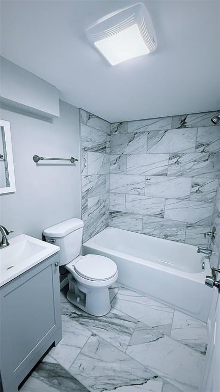 1204 Griefield Pl, Pagedale, MO 63133 - bathroom featuring vanity, toilet, bathing tub / shower combination, and marble look tile flooring