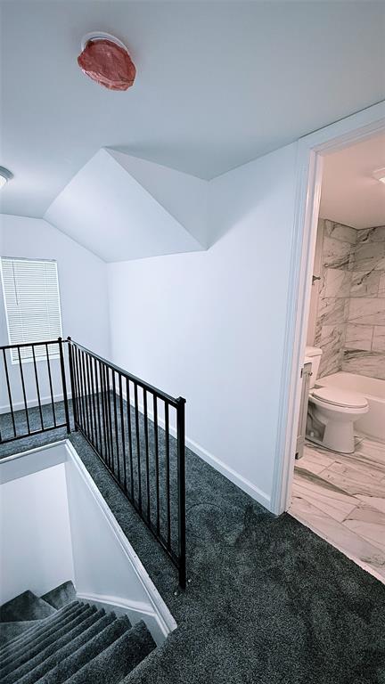 1204 Griefield Pl, Pagedale, MO 63133 - stairway featuring marble look tile flooring and baseboards