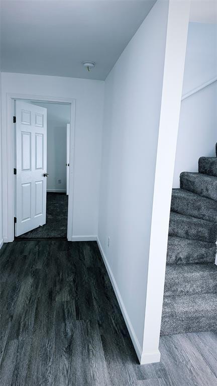 1204 Griefield Pl, Pagedale, MO 63133 - empty room featuring wood finished floors, baseboards, stairway, and a smoke detector