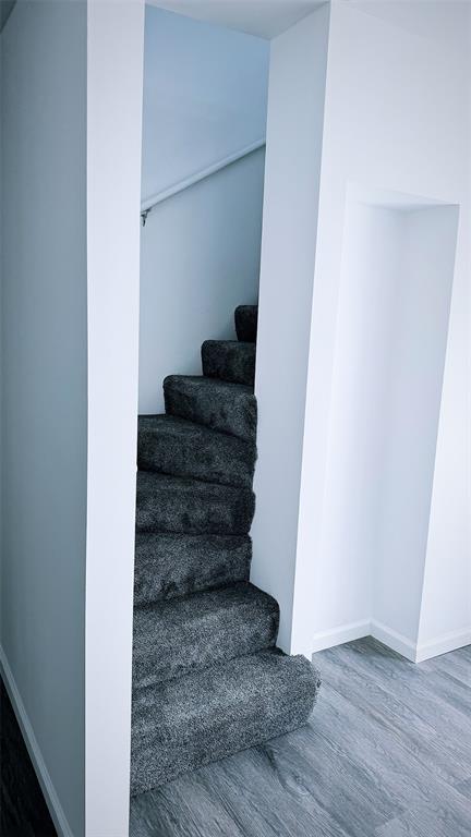 1204 Griefield Pl, Pagedale, MO 63133 - staircase featuring wood finished floors and baseboards